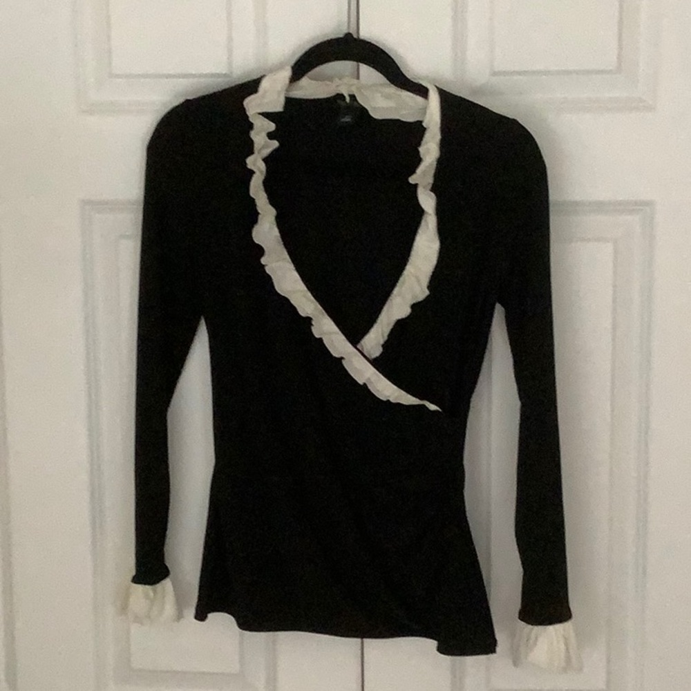 White House black market black top with white ruffled neck and sleeves.